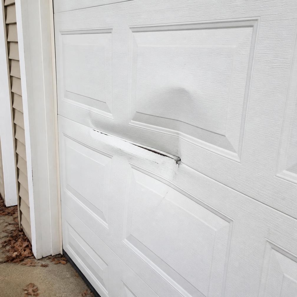 Damaged panels garage door repair by 24hr Garage Door Installation